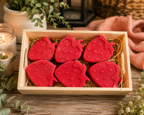 Hand-poured strawberry-shaped scented wax melts displayed in a rustic wooden gift box, perfect for wax warmers and thoughtful gifts from Warm Glow Candle Co.
