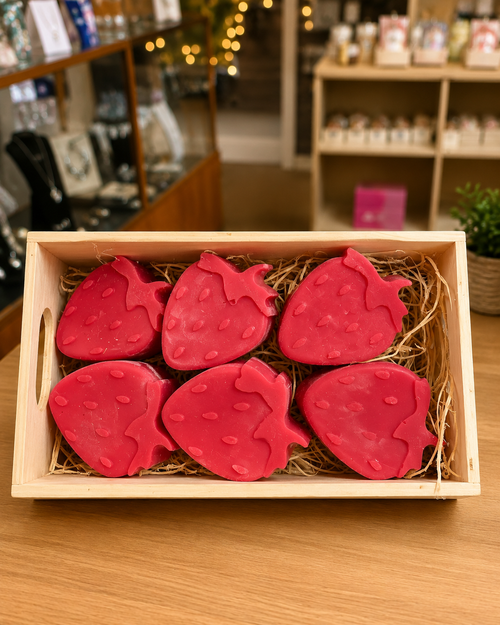 Hand-poured strawberry-shaped scented wax melts displayed in a rustic wooden gift box, perfect for wax warmers and thoughtful gifts from Warm Glow Candle Co.